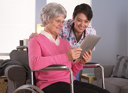 Photo of a nurse and elderly patient in wheelchair